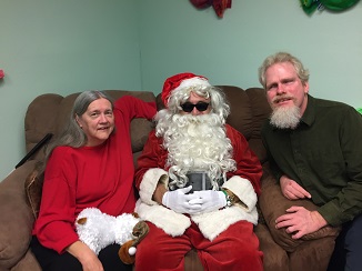 Lula, Santa and Kelly sitting on a couch